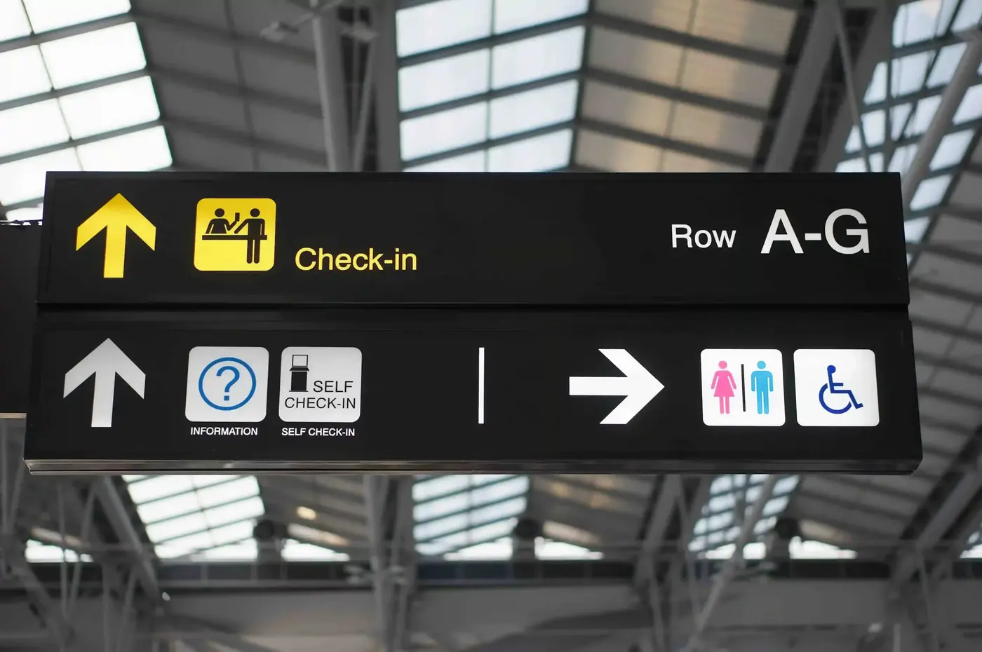 Overhead check-in and information signs in an airport terminal