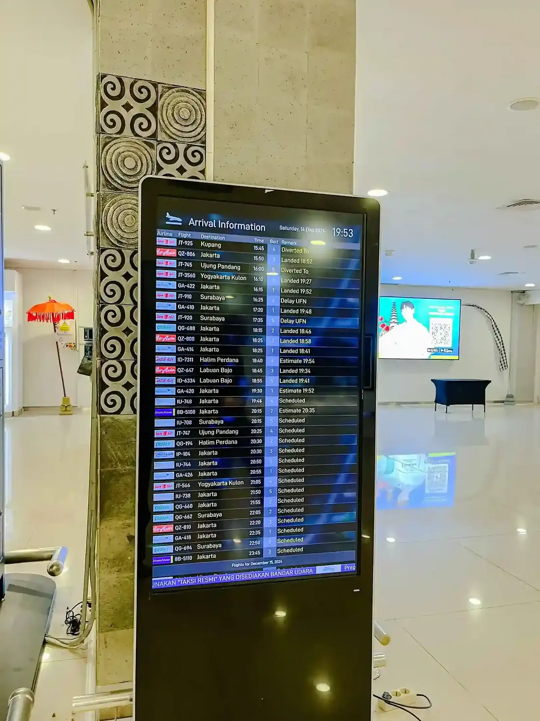 Arrivals information screen in a Bali airport terminal