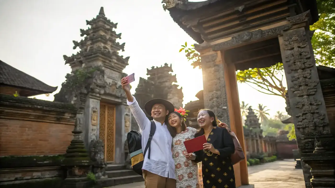 Family holding passports at a carved Balinese temple gate